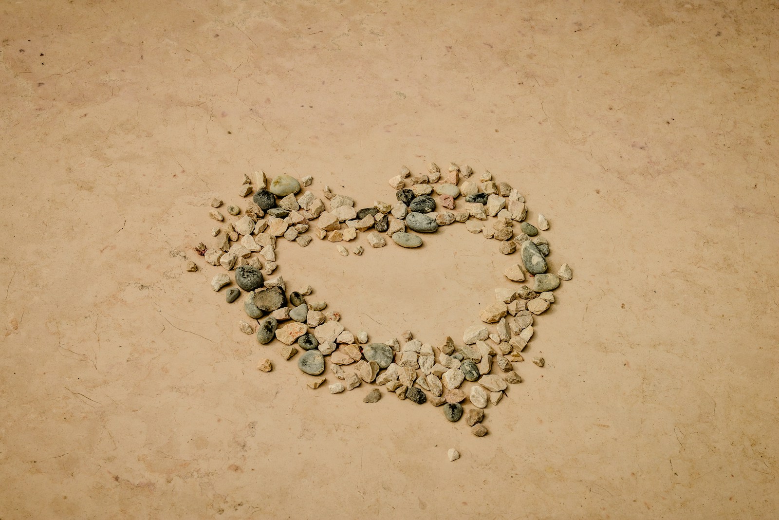 a heart made out of rocks on the ground