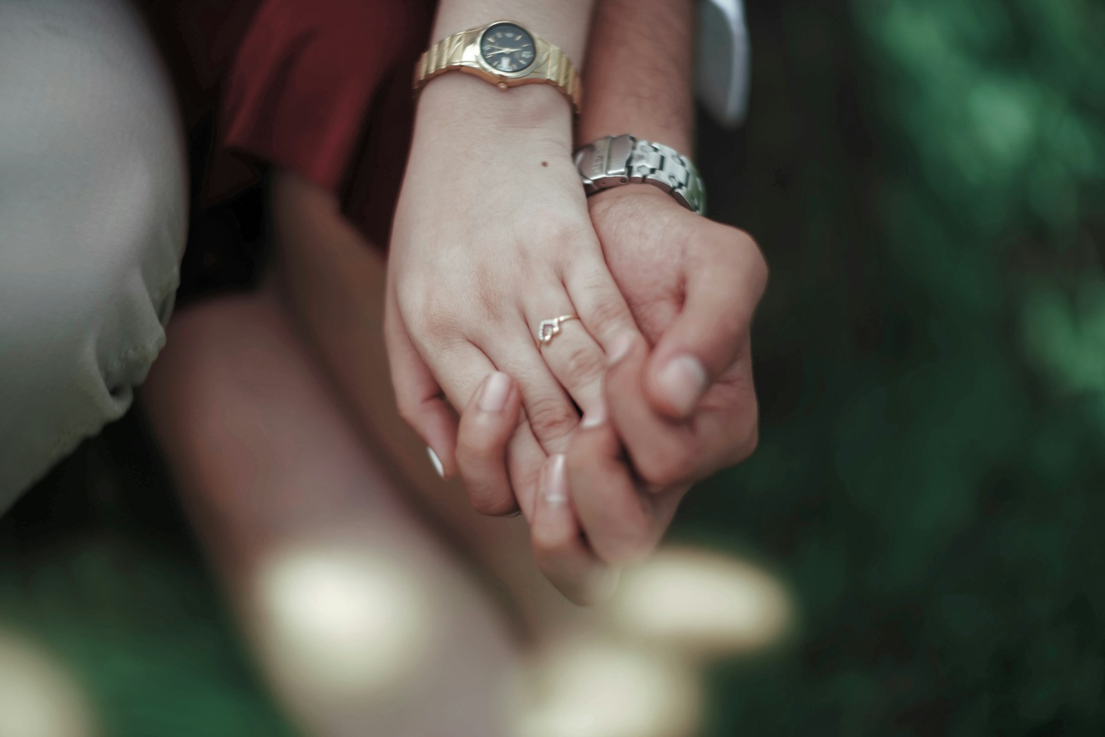 a close up of two people holding hands